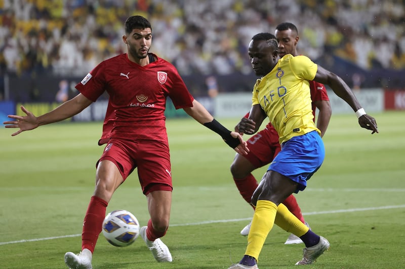 Duhail defender Yousef Aymen attempts to block a cross from Al Nassr forward Sadio Mane. AFP