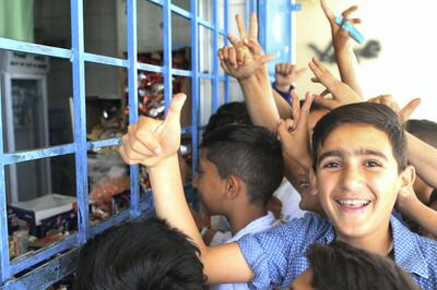 Schoolchildren shop candys at the mini market of the UNRWA AL Jofeh elementary school in Jofeh district in Amman, Jordan. (Salah Malkawi for The National)