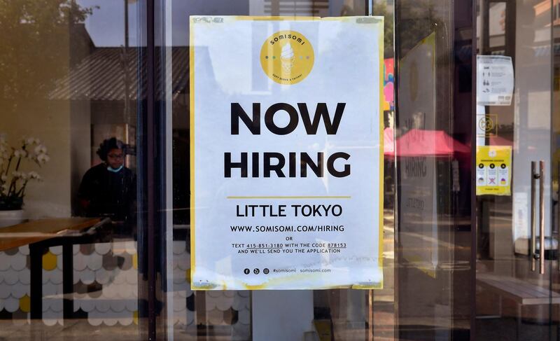 A 'Now Hiring' sign is posted in front of an ice-cream shop in Los Angeles, California on May 28, 2021.  Following over a year of restrictions due to the coronavirus pandemic, many jobs at restaurants, retail stores and bars remain unfilled, despite California's high unemployment rate, causing some owners to fear they will not be able to fully reopen by the June 15th date California has given for a full reopening of the economy. / AFP / Frederic J. BROWN

