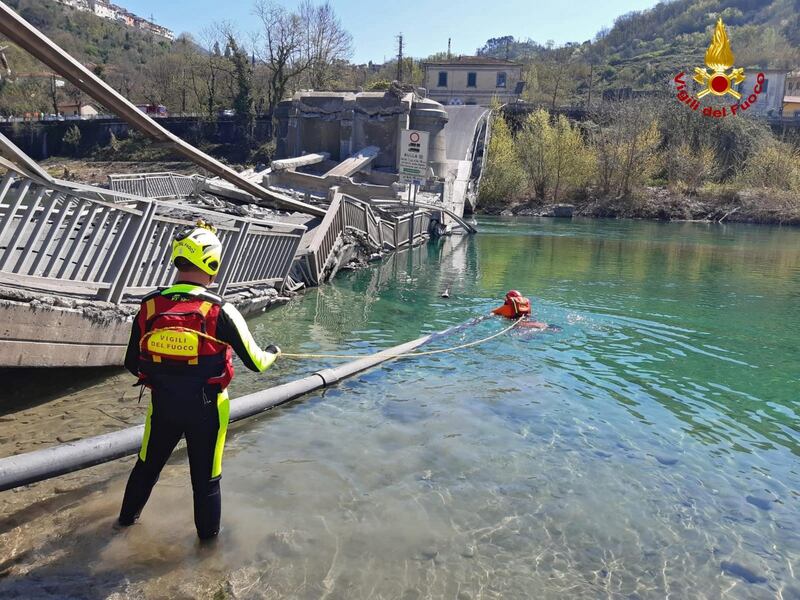 A handout photo made available by Italy's National Firefighters Corps, shows the collapsed bridge on a provincial road between Santo Stefano Magra and Albiano in, Tuscany, Italy.  EPA
