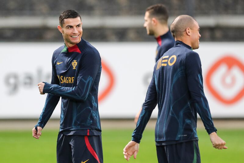 Portuguese players Cristiano Ronaldo (L) and Pepe (R) attend their team's training session in preparation for the FIFA World Cup 2022 in Qatar at Cidade do Futebol in Oeiras, near Lisbon, Portugal, 14 November 2022.   EPA/MIGUEL A.  LOPES
