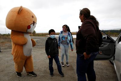 Jessie Larios, 33, from Los Angeles, wears a bear suit  while walking along Hollister Road in Gilroy, California, U.S., April 21, 2021.  Larios, also known as Bear Sun on social media, is walking from his home in Los Angeles to San Francisco while wearing the bear suit as a social media fundraising event.  REUTERS/Brittany Hosea-Small