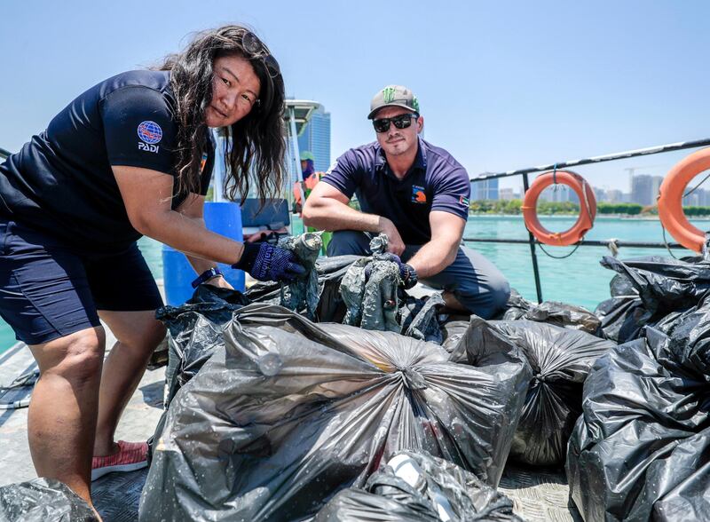 Abu Dhabi, United Arab Emirates, June 15, 2019.  
AUH clean up mission by volunteers at the Abu Dhabi Dhow Harbour. --  Dive volunteers with the collected bags of trash.
Victor Besa/The National
Section:  NA
Reporter:  Anna Zacharias