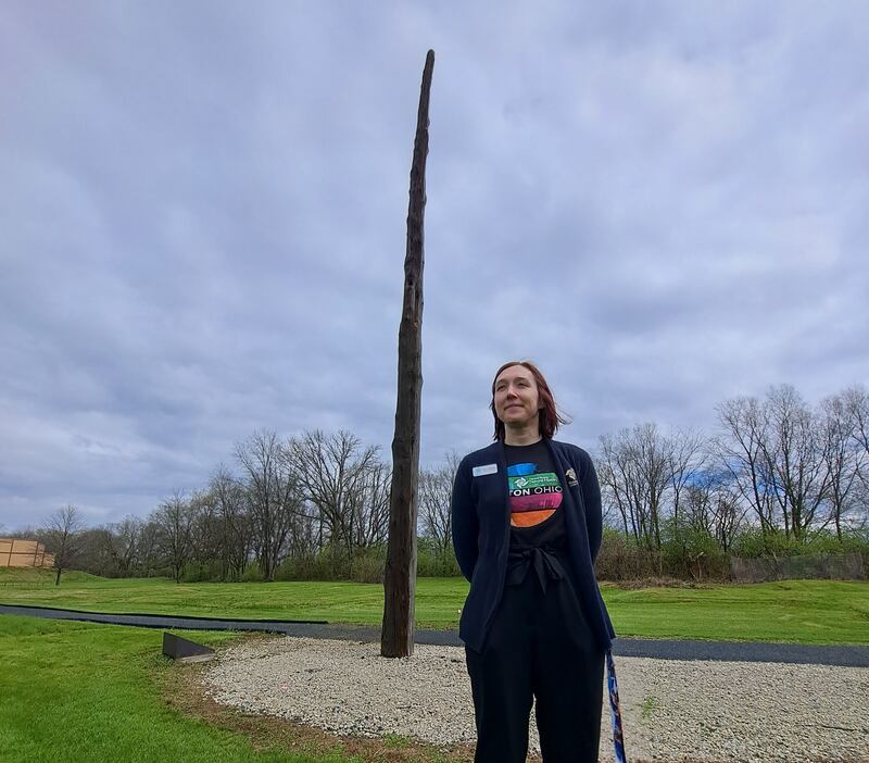 Taylor Hoffman, director of operations at SunWatch Indian Village, stands in front of the 800-year-old cedar pole that give this historical site its name. Stephen Starr / The National
