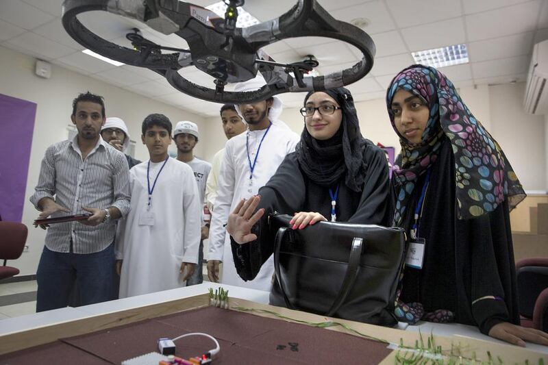 Fatima al Harmoudi, 15, and Reem Abdullah, 17, navigate a drone while they work with other students as part of Tech Quest. Silvia Razgova / The National