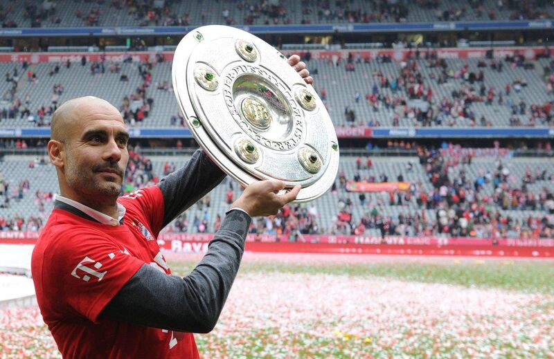 Bayern Munich's Spanish coach Pep Guardiola holding the trophy as they celebrate winning their 25th Bundesliga title after the German first division Bundesliga football match FC Bayern Munich vs 1 FSV Mainz 05 at the Allianz Arena in Munich, southern Germany on May 23, 2015. Pep Guardiola will leave Bayern Munich as head coach at the end of the season and be replaced by Carlos Ancelotti, the club states on Decmber 20, Christof Stache / AFP