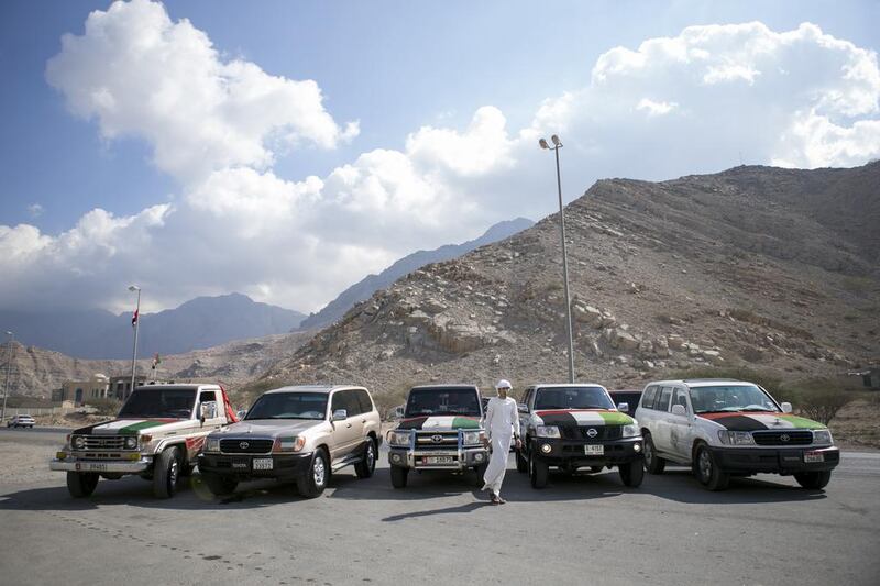 Ahmed Huraiz makes a final check on his friends’ cars before heading out from Wadi Shaam to Ras Al Khaimah’s corniche. Reem Mohammed / The National