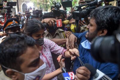 (FILES) In this file photo taken on September 6, 2020, Bollywood actress Rhea Chakraborty (C) struggles with media representatives gathering as she arrives at the Narcotics Control Bureau (NCB) office for enquiry regarding actor Sushant Singh Rajput's case, in Mumbai.  India has over four million coronavirus cases and an explosive border standoff with China, but the story dominating television news for months is how a Bollywood actress supposedly drove her ex-boyfriend to suicide with pot and black magic. - To go with India-film-Bollywood-suicide-media, FOCUS by Ammu Kannampilly
 / AFP / Punit PARANJPE                       / To go with India-film-Bollywood-suicide-media, FOCUS by Ammu Kannampilly
