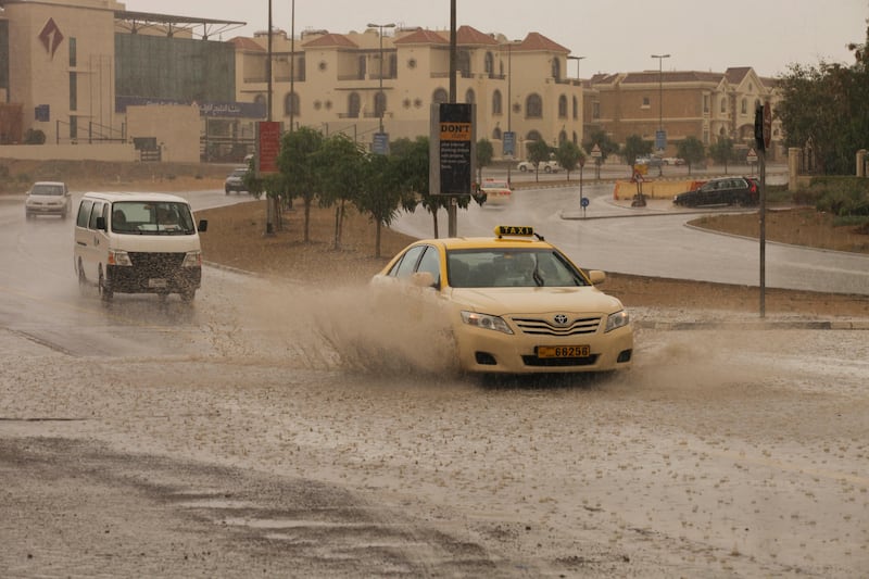 Dubai, United Arab Emirates - April 7 2013 - Motorists manouever areas of flooding in Uptown Mirdiff during intermittent heavy rains and a sandstorm.  tags: WEATHER (Razan Alzayani / The National)