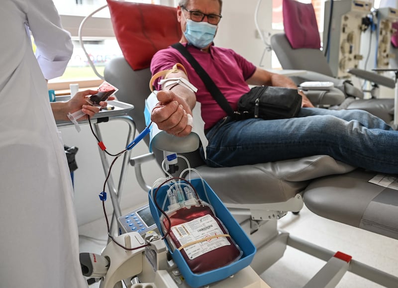 A man gives blood in Arras, northern France. For the most part, the global supply of blood and plasma largely depends upon the goodwill of voluntary donors. AFP
