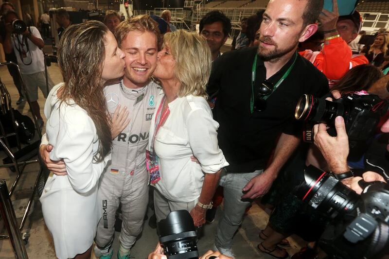Nico Rosberg of Germany and Mercedes-GP receives kisses from his wife Vivian Sibold, left, and his mother Sina Rosberg. Christopher Pike / The National