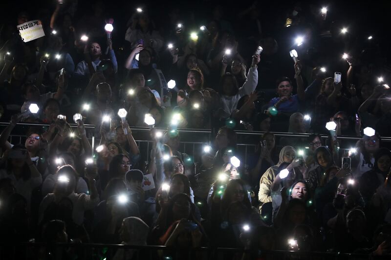 Fans light up the arena with their smartphones during a performance 