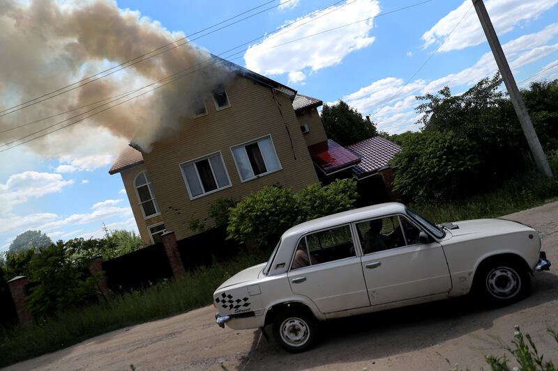 Plumes of smoke rise from a house on fire after a military strike by Russian forces in Kharkiv. Reuters
