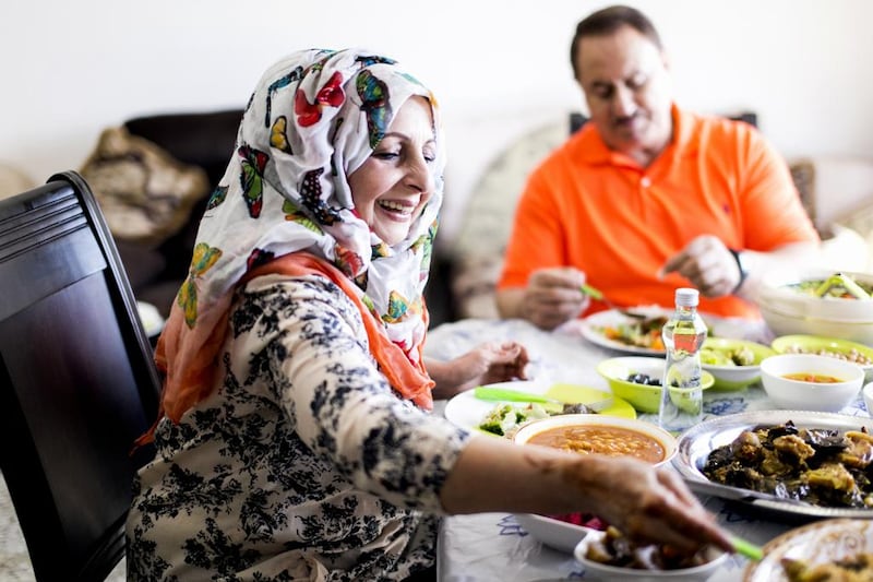 Basima Al Tamimi and her husband Aziz Al Tamimi enjoy a Iraqi meal at their home in Abu Dhabi. Reem Mohammed / The National