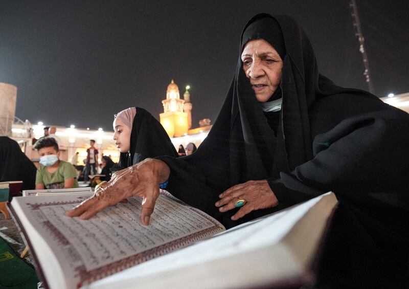 A woman reads the Quran at the Grand Mosque of Kufa near the central shrine city of Najaf, about 160 kilometres south of Iraq's capital Baghdad, during the month of Ramadan. AFP