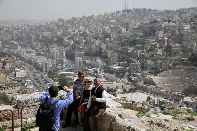 Tourists pose for a picture during their visit to the Amman Citadel, an ancient Roman landmark, in Amman. Reuters