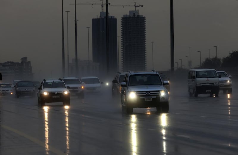 Cars drive through the rain on the Mohammed bin Zayed Road in Dubai.  Satish Kumar / The National