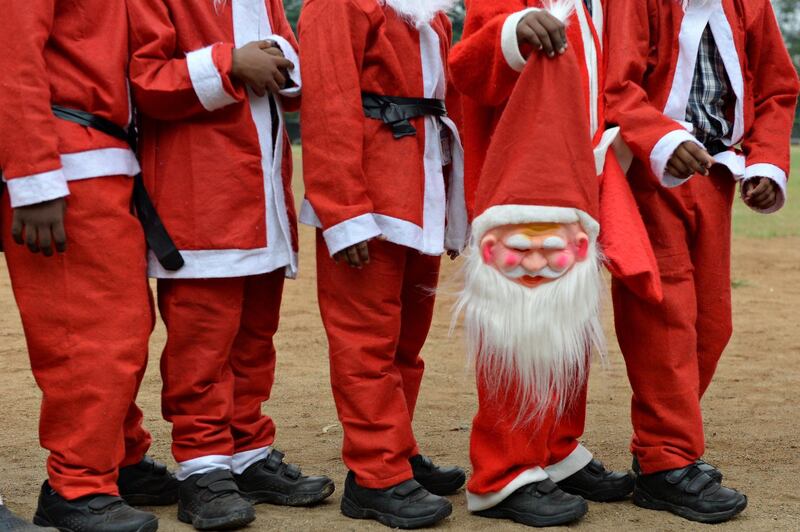 Indian schoolchildren dressed as Santa Claus take part in a Christmas event at a school in Chennai. AFP