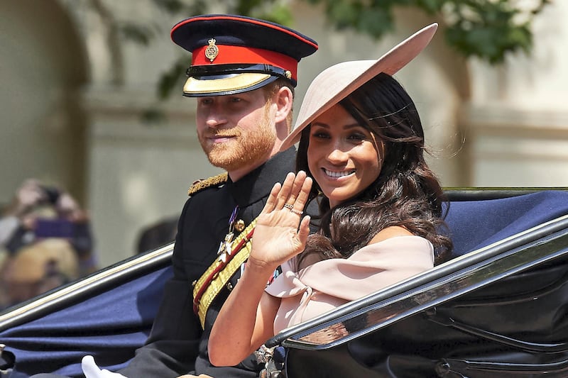 Britain's Prince Harry, Duke of Sussex and Britain's Meghan, Duchess of Sussex return in a horse-drawn carriage after attending the Queen's Birthday Parade, 'Trooping the Colour' on Horseguards parade in London on June 9, 2018. - The ceremony of Trooping the Colour is believed to have first been performed during the reign of King Charles II. In 1748, it was decided that the parade would be used to mark the official birthday of the Sovereign. More than 600 guardsmen and cavalry make up the parade, a celebration of the Sovereign's official birthday, although the Queen's actual birthday is on 21 April. (Photo by Niklas HALLEN / AFP)