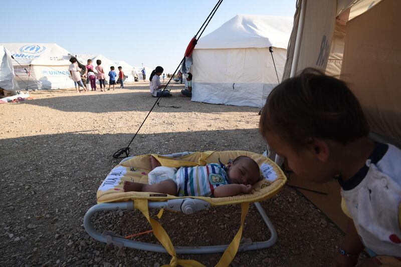 A baby sleeps at a refugee camp in Nea Kavala, northern Greece. About 1,500 asylum-seekers transported from Greece's eastern Aegean island of Lesbos to the mainland. Around 1,000 of those transferred and housed in Nea Kavala, where they will be staying in tents until the end of the month, after which they will be transferred to a new camp under construction.  AP