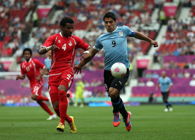 MANCHESTER, ENGLAND - JULY 26:  Luis Suarez of Uruguay battles with Mohamed Ahmad of the United Arab Emirates during the Men's Football first round Group A Match of the London 2012 Olympic Games between UAE and Uruguay, at Old Trafford on July 26, 2012 in Manchester, England.  (Photo by Julian Finney/Getty Images)