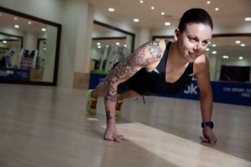 Eva Clarke, a 33-year-old Australian, is attempting to break two world records for back-of-hand push-ups. Silvia Razgova / The National
