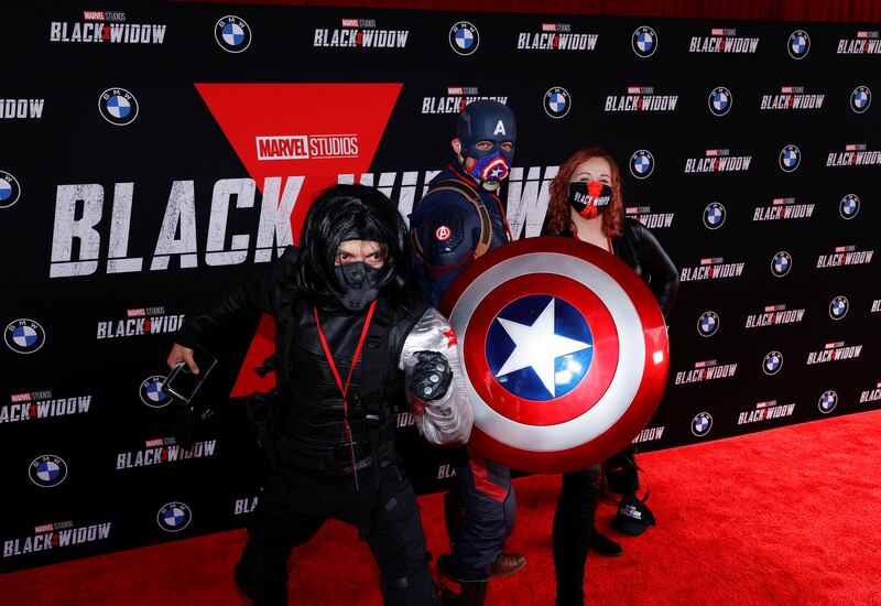 People dressed as Avengers characters pose as they attend a fan event and special screening of the film 'Black Widow' at El Capitan theatre in Los Angeles, California, US , June 29, 2021. Reuters