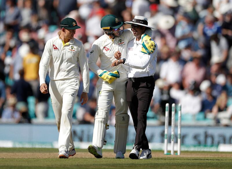 Australia captain Tim Paine with his arm around Umpire Kumar Dharmasena as as the players head off for lunch at The Oval. Getty