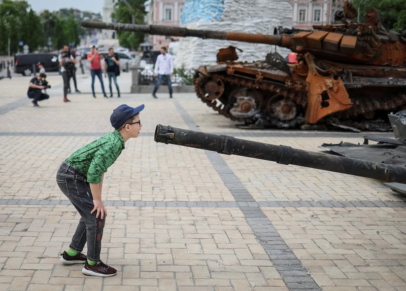 A boy examines the wreck of a Russian infantry fighting vehicle during an exhibition in Kyiv, Ukraine. Reuters