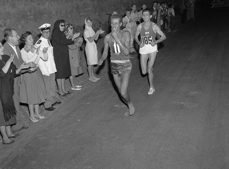 Ethiopian athlete Abebe Bikila running barefoot for victory during the Rome 1960 Olympic Games marathon, after passing Moroccan Abdeslam Radi. AFP Photo 