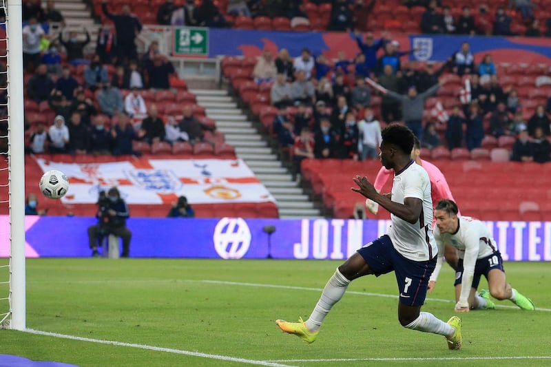 England's defender Bukayo Saka scores the opening goal. AFP