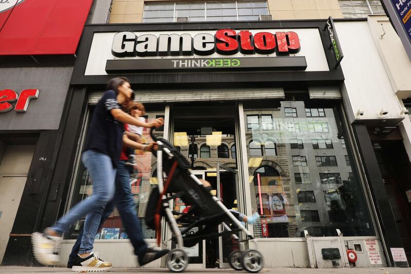 NEW YORK, NEW YORK - SEPTEMBER 16: People pass a GameStop store in lower Manhattan on September 16, 2019 in New York City. GameStop has announced that they will be closing between 180 and 200 stores before the end of the fiscal year due to a drop in sales.   Spencer Platt/Getty Images/AFP
== FOR NEWSPAPERS, INTERNET, TELCOS & TELEVISION USE ONLY ==
