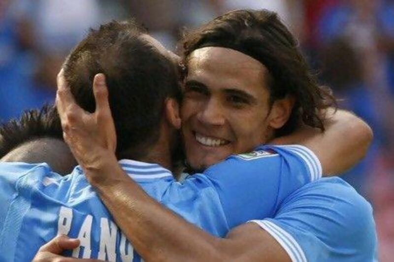 Edinson Cavani, the Napoli striker, right, needs another 43 goals to go past Diego Maradona's record at the Serie A club. Carlo Hermann / AFP