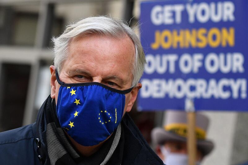 EU chief Brexit negotiator Michel Barnier, wearing an EU flag-themed facemask due to the novel coronavirus pandemic, leaves the conference centre in London on October 28, 2020 to return to his hotel as he attends the latest round of Brexit trade talks with the UK.  Britain and the European Union launched an all-out round of Brexit talks vowing to work round the clock to seal a trade deal in the slender time left. / AFP / JUSTIN TALLIS
