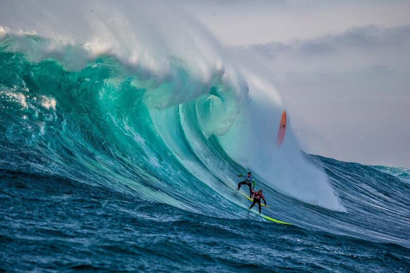 Josh Kerr, in red, rides a wave with Carlos Burle of Brazil during the Final of the Todos Santos Challenge off the coast of Baja, Mexico. Richard Hallma / World Surf League / EPA
