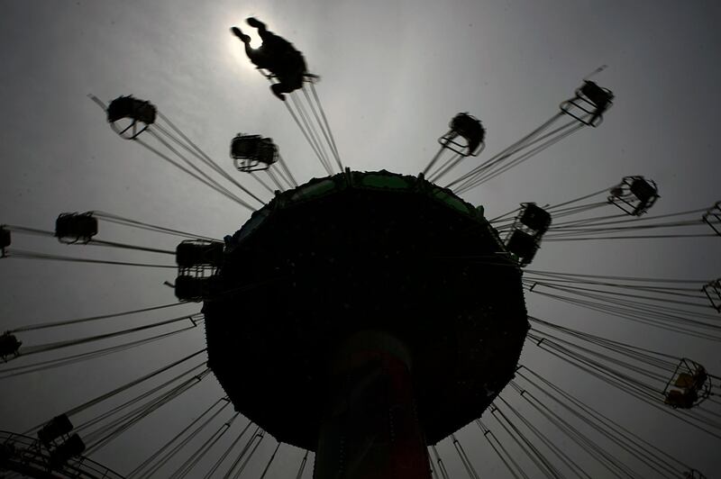 A visitor enjoys the swing ride at the Yomiuriland amusement park in Tokyo. The park has been closed since the end of March due to the new coronavirus, has taken measures to prevent infections and reopened limited attractions. AP Photo