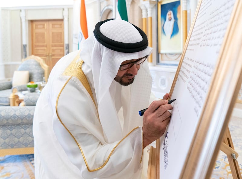 ABU DHABI, UNITED ARAB EMIRATES - August 24, 2019: HH Sheikh Mohamed bin Zayed Al Nahyan, Crown Prince of Abu Dhabi and Deputy Supreme Commander of the UAE Armed Forces, signs a board announcing the introduction of a postage stamp celebrating 150 years since the birth of Mahatma Gandhi,  during a reception at Qasr Al Watan.

( Rashed Al Mansoori / Ministry of Presidential Affairs )
---