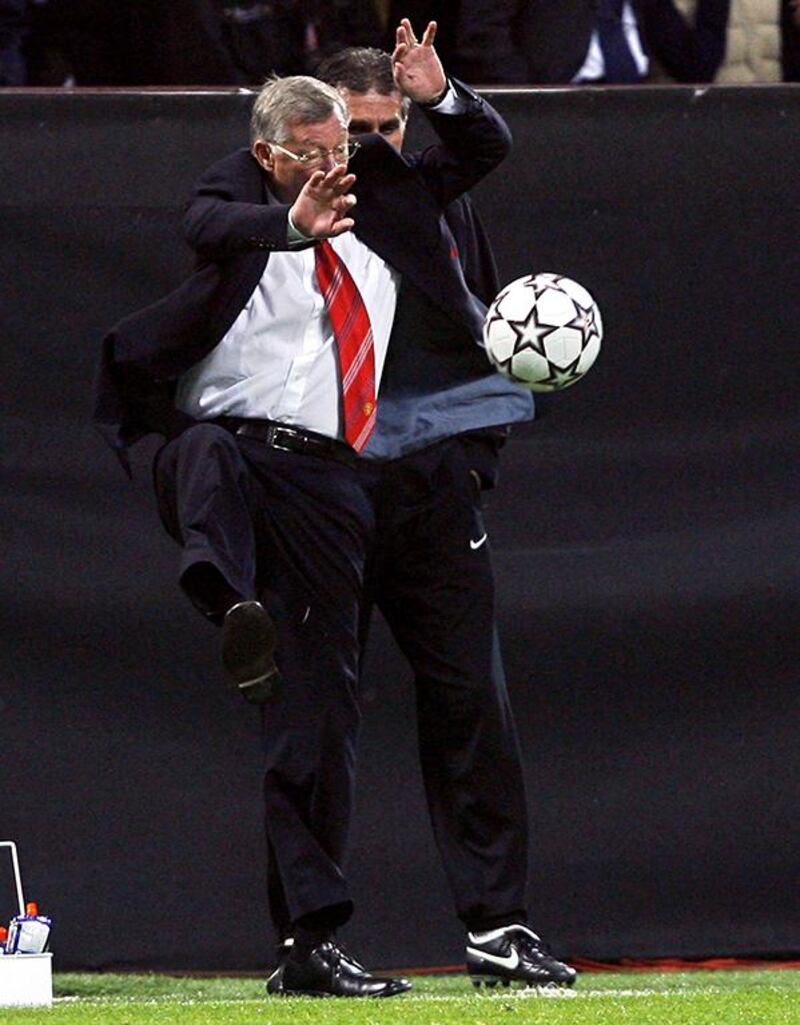 Manchester United manager Alex Ferguson prepares to kick the ball during the European Champions League semi final second leg football match against AC Milan at Milan's San Siro stadium, Italy, 02 May 2007. AFP PHOTO / ANDREW YATES (Photo by ANDREW YATES / AFP)