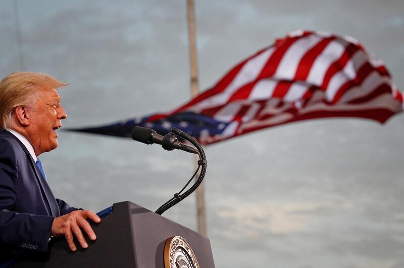 FILE PHOTO: FILE PHOTO: President Donald Trump speaks, with a flag behind him, during a campaign rally at Cecil Airport in Jacksonville, Florida, September 24, 2020. REUTERS/Tom Brenner/File Photo/File Photo