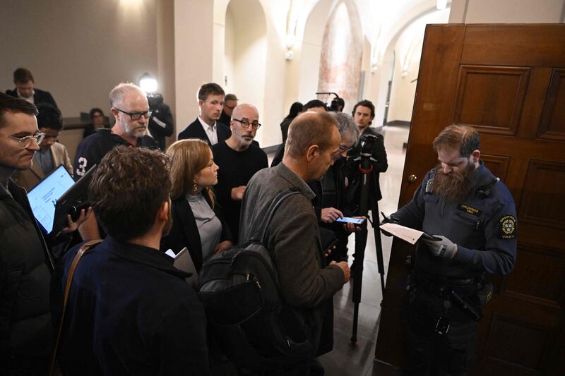 Trial observers queue in front of a courtroom of the district court where two brothers suspected of having spied on Sweden for ten years for the Russian intelligence service GRU stand trial. AFP