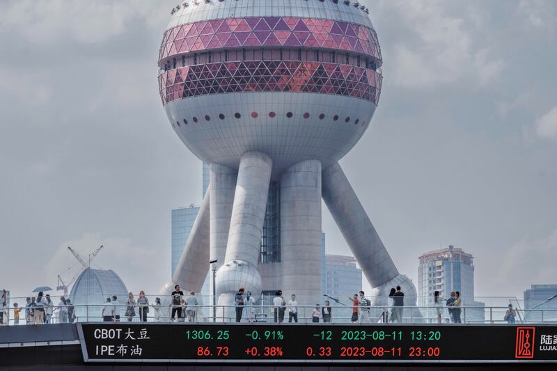 A pedestrian bridge with a screen showing stock exchange data, in Shanghai. EPA