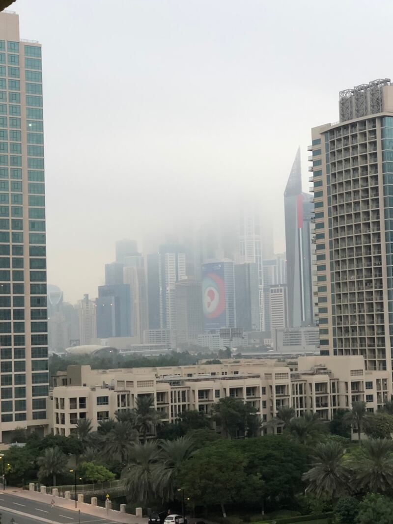 Dubai Marina is partially obscured by low cloud about 6am on Thursday. The National