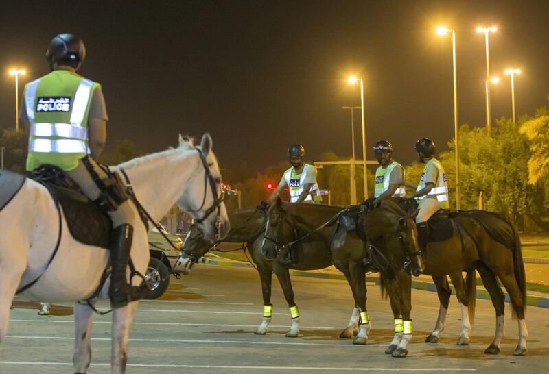 Abu Dhabi, United Arab Emirates- Police officers preparing to do patrol in a horse in Al Mushrif.  Leslie Pableo for The National for Haneen Dajani's story
