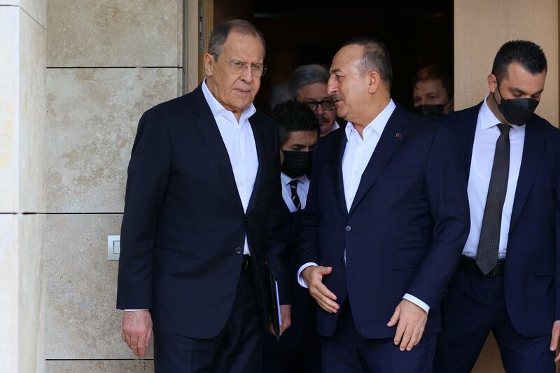 Mr Cavusoglu talks to Mr Lavrov. Reuters