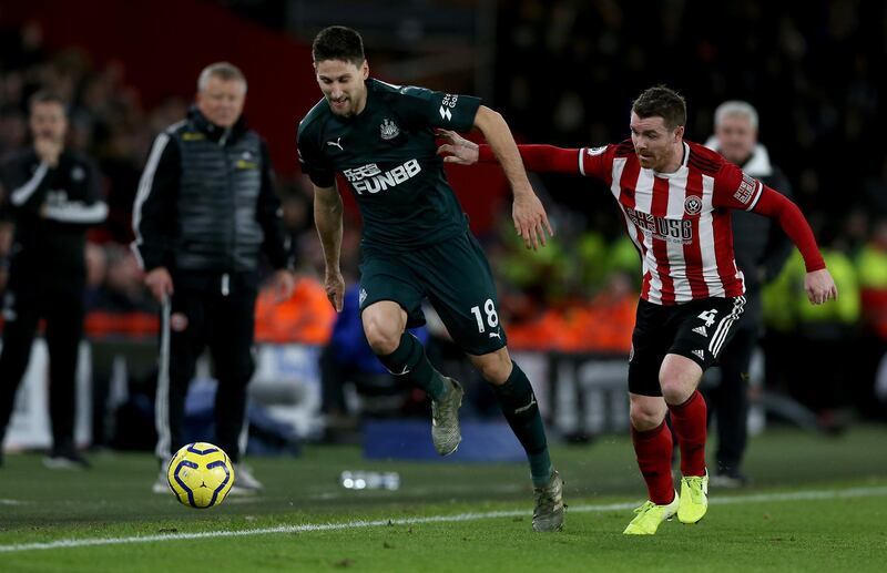 SHEFFIELD, ENGLAND - DECEMBER 05: John Fleck (R) of Sheffield challenges Federico Fernandez of Newcastle during the Premier League match between Sheffield United and Newcastle United at Bramall Lane on December 05, 2019 in Sheffield, United Kingdom. (Photo by Nigel Roddis/Getty Images)