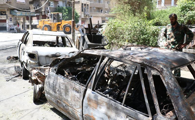 epa06061477 A man looks at burnt and damaged cars after a car bomb explosion near the al-Ghadir Square in the al-Amara neighborhood in Damascus, Syria, 02 July 2017. According to the state TV, three car bomb blasts rocked the capital  Damascus on 02 July that killed at least eight people and wounded a dozen others. It said that three car bombs went off at the Airport Road and al-Amara neighborhood in Damascus city. It indicated that the authorities chased the three cars and managed to intercept two of them near the entrance of Damascus city at the airport roundabout and destroyed them, but the third car managed to arrive in the capital and the suicide bomber on board detonated it, killing a number of people and injuring others.  EPA/YOUSSEF BADAWI
