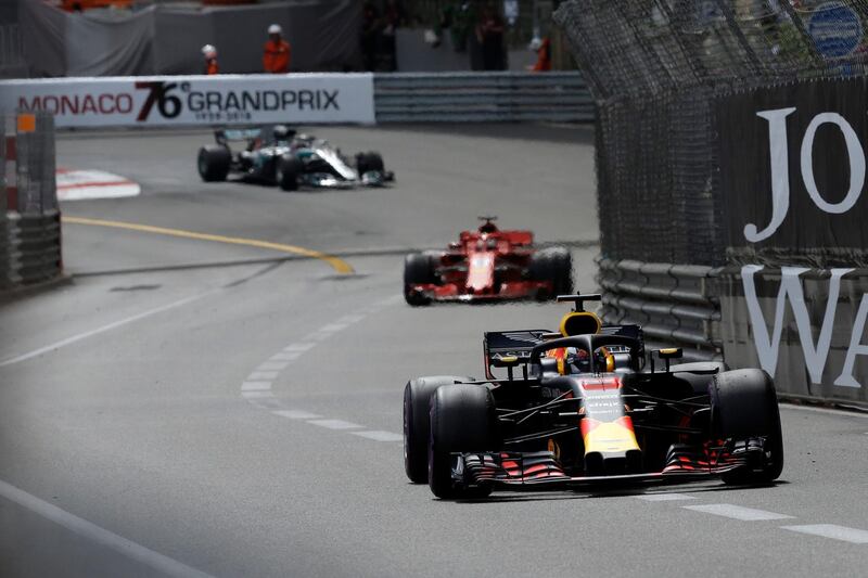 Red Bull driver Daniel Ricciardo of Australia leads the race, at right, followed by Ferrari driver Sebastian Vettel of Germany and Mercedes driver Lewis Hamilton of Britain during the Formula One race, at the Monaco racetrack, in Monaco, Sunday, May 27, 2018. (AP Photo/Claude Paris)