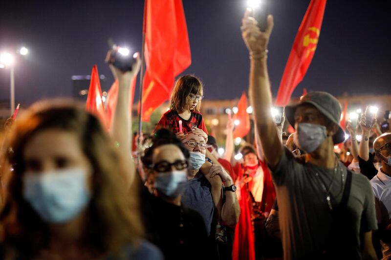 People wearing face masks protest against Israeli Prime Minister Benjamin Netanyahu's plan to annex parts of the Israeli-occupied West Bank, in Tel Aviv, Israel, on June 6, 2020. Reuters