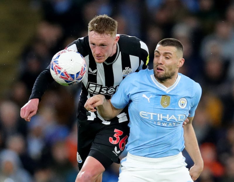 Newcastle United's Sean Longstaff challenges Manchester City's Mateo Kovacic. Reuters