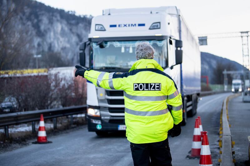 A police officer directs a lorry coming from Austria into a border checkpoint near Kiefersfelden, Germany, where entry rules at the border with the Austrian state of Tyrol have been tightened. AP Photo